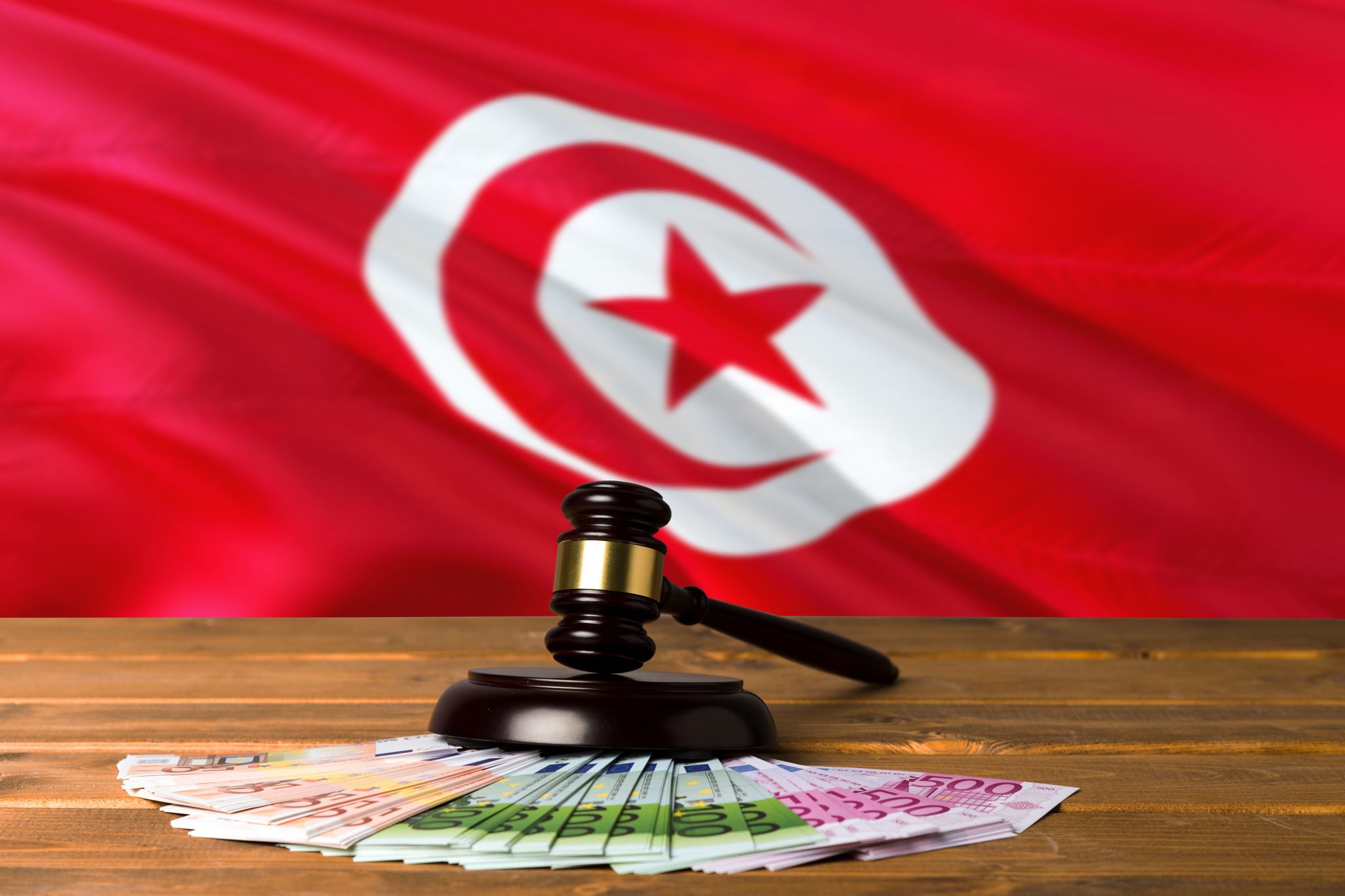 Tunisian flag with gavel and currency